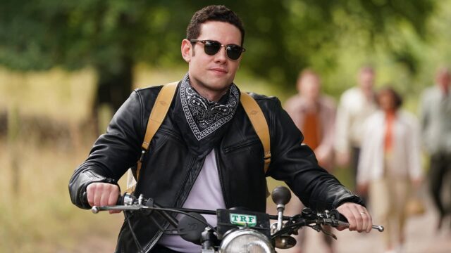 Tom Brittney as Will Davenport riding a motorcycle in Grantchester Season 8